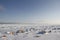 Rocks in the snow under a blue sky in the arctic, north of Arviat