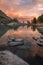 Rocks And Trees Reflecting In Pink Waters Of Sunset Mountain Lake, Altai Mountains Highland Nature Autumn Landscape