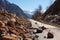 Rocks tumbling in early spring make the road through mountains perilous