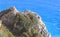 Rocks, vegetation and ancient stones in front of the sea