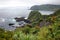 Rocks in water, lush foliage cliffs and ocean view