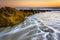 Rocks and waves in the Atlantic Ocean at sunrise in Palm Coast,
