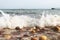 The rocks were washed away at the beach wave and peoples boating, kayaking in ocean scenry