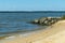 Rocks of the York River shore, and the forest on the horizon in Gloucester Virginia US