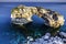 A rocky arch in the transparent sea water, Sa Ponta, Mallorca