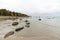 Rocky autumn beach with waves crashing on the rocks