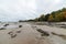 Rocky autumn beach with waves crashing on the rocks