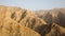 Rocky and barren Hajar Mountains mountain range during sunset seen from Jebel Jais Viewing Deck Park, United Arab Emirates