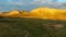 Rocky and barren mountains of Mani, Greece, painted golden by the setting sun