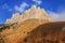 Rocky bastion of Bolshoy Big Tkhach mountain peak in Caucasus Mountains at autumn. Scenic blue sky landscape