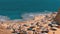 Rocky beach in a bay with umbrellas and sunbeds in Egypt on Red Sea.