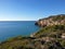 Rocky beach, coastline with turquoise sea, hiking in Sitges, Spain