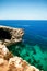 Rocky Beach and Grotto with Blue water