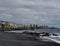 Rocky beach at low tide and city