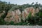 Rocky beach with red interesting geology and mediterranean vegetation, remote place