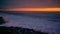 Rocky beach, sea waves. Sunset at dusk