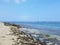 Rocky beach with Shallow wavy ocean waters of Camp Mokuleia Beach