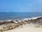 Rocky beach with Shallow wavy ocean waters of Camp Mokuleia Beach