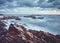 Rocky beach at sunset, color toned long exposure picture