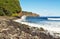 Rocky beach, surf, and cliffs of Hawaii