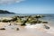 Rocky breakwater on beach at Bennlech