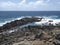 Rocky Caribbean coastline with turquoise whitewater under tropical blue sky. Rocks carved by the tropical waters of FWI. Magical