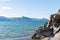 Rocky cliff face with view of Okanagan Lake and Giant`s Head mountain on sunny day