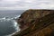 Rocky cliff next to a sea.