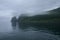 Rocky cliffs of the coastline of Shiretoko National Park hidden in a heavy layer of fog, Shiretoko National Park