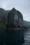 Rocky cliffs of the coastline of Shiretoko National Park hidden in a heavy layer of fog, Shiretoko National Park