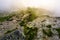 Rocky cliffs of Fagaras mountains in fog