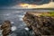 Rocky cliffs in Kilkee at sunset, County Clare. Ireland