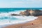 Rocky cliffs, sandy beach, and people enjoying beautiful sunny day. Montana de Oro State park, Los Osos, California Central Coast