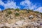 Rocky climb up the mountain and blue sky with clouds