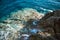 Rocky coast of the Adriatic sea. Rocks and clear sea Water. Waves break on the shore.