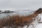 Rocky coast of the Atlantic Ocean covered with snow. Gloomy Winter Atlantic Ocean. USA. Maine.