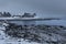 Rocky coast of the Atlantic Ocean covered with snow. Gloomy Winter Atlantic Ocean. USA. Maine.