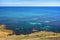 Rocky coast of calm Mediterranean sea with underwater rocks