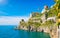 Rocky coast and clear blue sea next to beautiful Amalfi, Campania, Italy. Amalfi coast is most popular travel and holiday