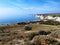 Rocky coast of Eastern Cyprus. High cliffs high above the sea. Summer sunny marine landscape.