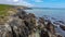 The rocky coast of the island of Ireland. A rocky reef in the Celtic Sea. Beautiful coastline of northern Europe. Nature of