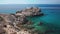 Rocky coast line of Mykonos Island, Greece. Speedboat on the background.