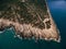 Rocky coast of the Lustica peninsula in Montenegro. Aerial drone view. Foamy waves hit the coast.