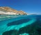 Rocky coast with seagrass and sand underwater