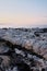 Rocky coast. Sharp stone rows, breaking waves. Majestic landscapes blue tint