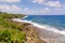 The rocky coast of a tropical island. Siargao, Philippines. Seascape in sunny weather.