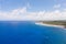 The rocky coast of a tropical island. Siargao, Philippines. Seascape in sunny weather.