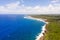 The rocky coast of a tropical island. Siargao, Philippines. Seascape in sunny weather