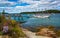 Rocky coast and view of boats in the harbor at Bar Harbor, Maine