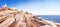 The rocky coastline of the Atlantic Ocean with interesting stones and a lighthouse.